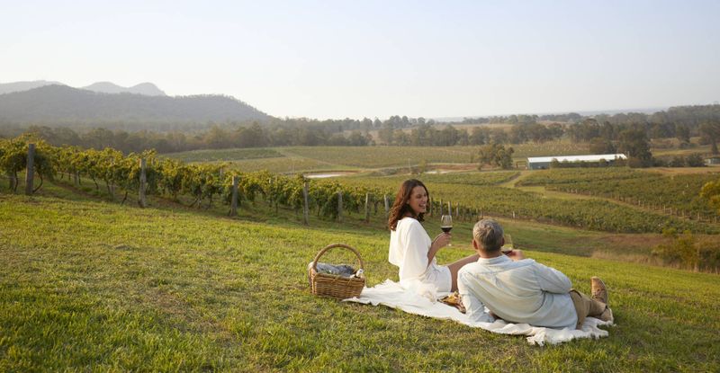 Photo of couple sitting looking over wineries